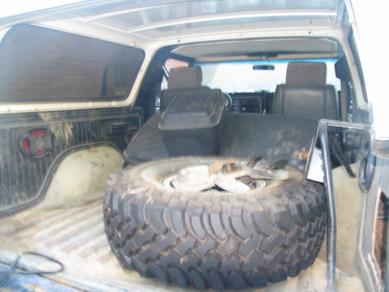 1978 Ford Bronco interior showing spare tire in cargo area and front seats