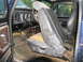 1978 Ford Bronco - The interior of a 1978 Ford Bronco reveals worn seats, exposed wiring, and a dated dashboard.