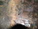 1978 Ford Bronco - Close-up of a corroded metal surface, likely a vehicle's floor pan, showing signs of wear and damage.