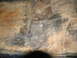 1978 Ford Bronco - Close-up of a heavily rusted vehicle floor pan showing welded repairs.