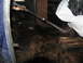 1978 Ford Bronco - Someone is pressure washing the interior floor of a vehicle, which is covered in dirt and grime.