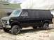 1979 Ford Bronco - A black van with tinted windows and off-road tires sits on a dirt lot.