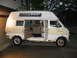 1971 Ford E350 - Side view of a 1971 Ford E350 van conversion, showing the interior with a stove and cabinets.