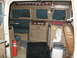 1971 Ford E350 - The interior of a converted van shows a compact living space with a stove, sink, and seating area.