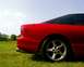 1993 Ford Probe - Rear view of a red 1993 Ford Probe with a five-spoke wheel and dual exhaust pipes.