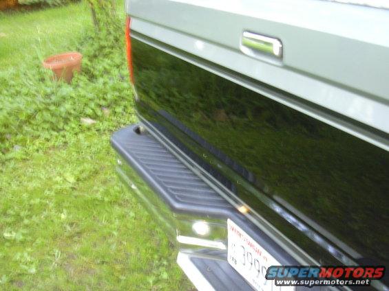 1992 Ford F-250 rear corner with black and silver two-tone paint, chrome bumper, and license plate