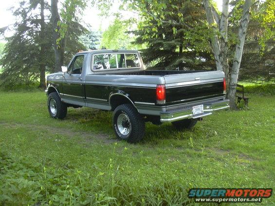 1992 Ford F-250 pickup truck parked in grassy yard with trees