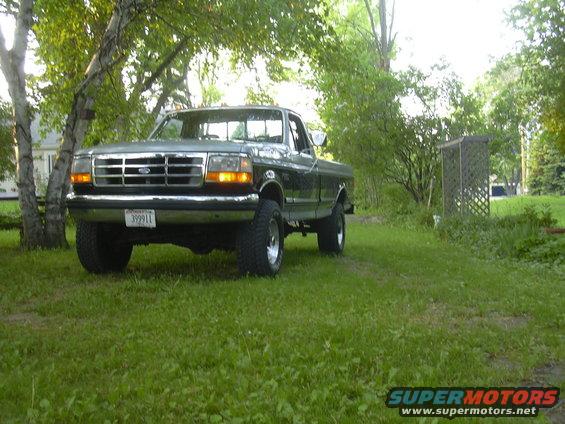 1992 Ford F-250 pickup truck parked on grass with trees in background
