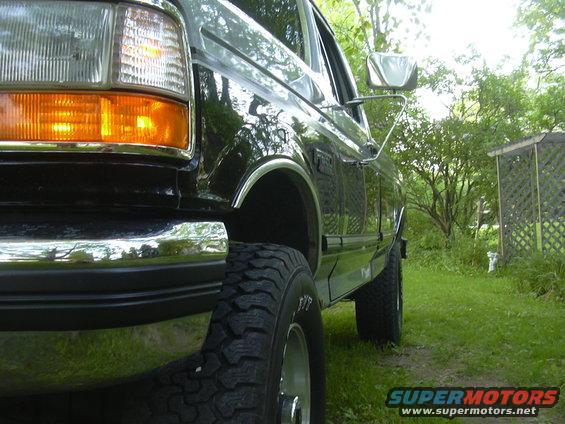 Black 1992 Ford F-250 pickup truck, front quarter view, parked on grass