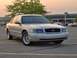 2002 Ford Crown Victoria - A silver 2002 Ford Crown Victoria is parked in a lot with a shopping center in the background.