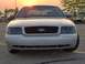 2002 Ford Crown Victoria - Front view of a silver 2002 Ford Crown Victoria parked in a lot during sunset.