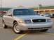 2002 Ford Crown Victoria - A silver 2002 Ford Crown Victoria is parked in a lot with a black grille and aftermarket wheels.