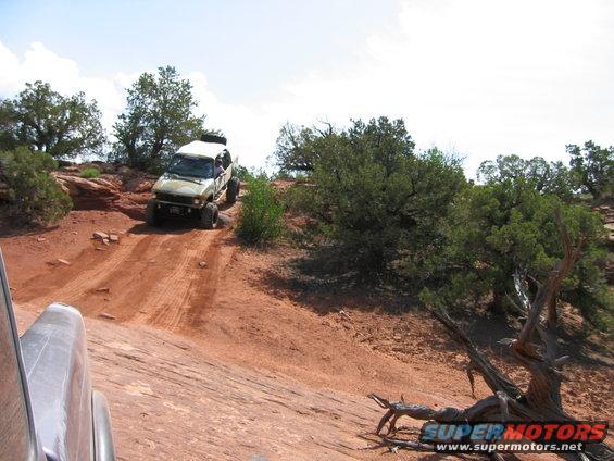 1997 Ford Ranger climbing a steep dirt trail with another vehicle visible in the foreground