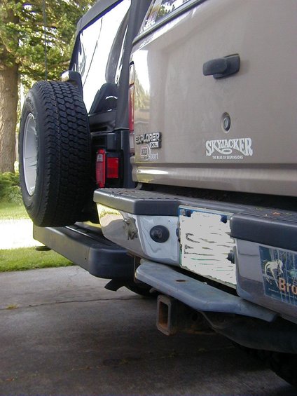 Tan 1995 Ford Explorer rear bumper with spare tire mounted on the left
