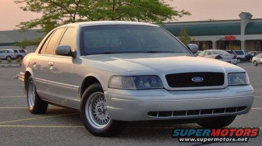 Silver 2002 Ford Crown Victoria, 3/4 front view. Aftermarket wheels