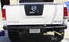 1984 Ford Bronco - Rear view of a white Nissan Titan pickup truck with a custom bumper and exhaust.