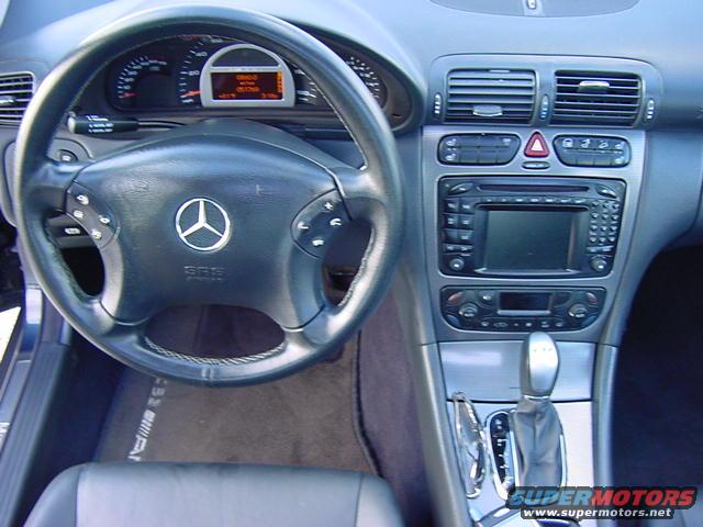 Interior of a 2002 Mercedes-Benz C-Class showing the steering wheel, dashboard, and center console