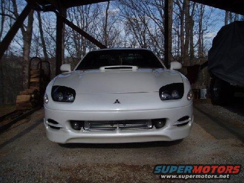 Front view of a white 1994 Dodge Stealth R/T Twin Turbo parked under a covered structure