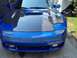 1994 Dodge Stealth - Front view of a blue sports car a carbon fiber hood and the Supermotors logo at the bottom.