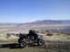 2005 Honda TRX 450 R - An ATV sits on a dusty hill overlooking a vast, arid landscape under a clear blue sky.