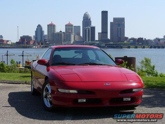 Red 1991 Ford Probe front view with pop-up headlights