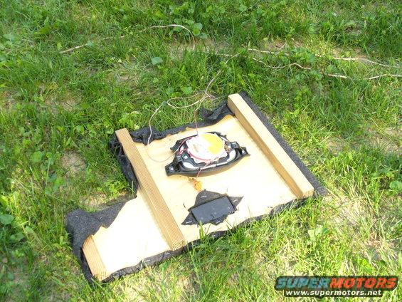 Car speaker on wooden frame with wires
