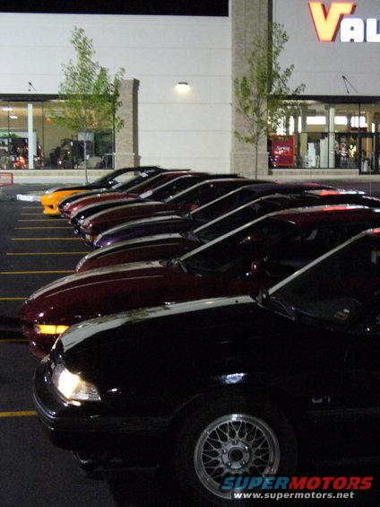 Black 1991 Ford Probe in a line of cars
