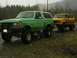 1978 Ford Bronco - Two Ford Broncos parked outdoors during a rain shower.