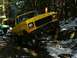 1978 Ford Bronco - Yellow 1978 Ford Bronco navigating a challenging off-road trail in a snowy forest.