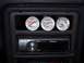 1987 Ford Thunderbird - Interior view of a car's dashboard displaying water, oil, and voltage gauges above a car stereo.