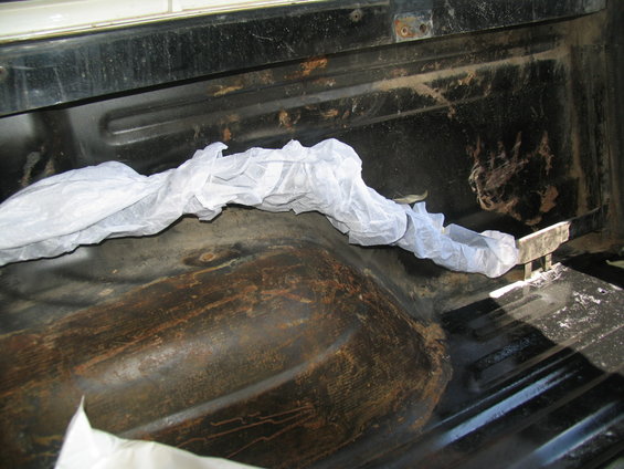 1978 Ford Bronco cargo area with white protective covering over a metal bar