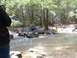 1991 Ford Bronco - A Ford Bronco navigates a rocky stream bed surrounded by a dense forest.