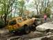 1991 Ford Bronco - SUV attempts to climb over large rocks on a challenging off-road course.