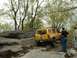 1991 Ford Bronco - A yellow SUV navigates a rocky trail with several people observing the off-road adventure.
