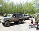 1991 Ford Bronco - A group of off-road vehicles are gathered in a wooded area.