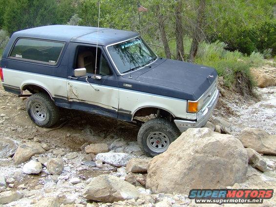 1987 Ford Bronco, blue and white, 3q-front view, off-roading