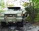 1991 Ford Bronco - A tan 1987 Ford Bronco is parked on a dirt path with another vehicle behind it.