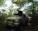 1991 Ford Bronco - Off-road scene with a Ford Bronco and a person. A Jeep is visible in the background.