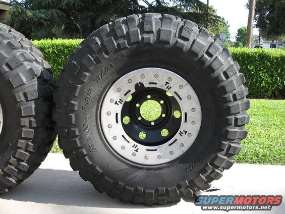 Off-road tire with aggressive tread and a silver beadlock wheel. Text on tire reads 'Krawler TA'