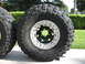1983 Ferrari Enzo - A close-up view of an off-road tire and wheel assembly, not a 1983 Ferrari Enzo.