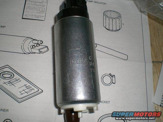 Silver fuel pump with black top and brown bottom, resting on diagrams