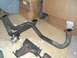 1995 Ford Probe - Exhaust components, including a manifold and pipes with a wastegate, are laid out on a floor near cardboard boxes.