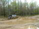1991 Ford Bronco - A 1991 Ford Bronco navigates a muddy trail, kicking up water and mud as it gets stuck.