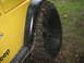 2001 Jeep Wrangler - A yellow Jeep Wrangler is shown from the side, with its tire covered in mud.
