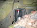 2001 Jeep Wrangler - Close-up of a vehicle's suspension component, showing a shock absorber mount with visible dirt and debris.