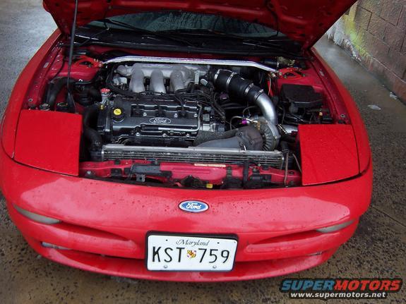 Red 1995 Ford Probe with hood open showing the engine and front end. Maryland license plate KST 759