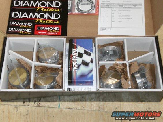 Box containing Diamond Pistons and Total Seal piston rings, with product documentation