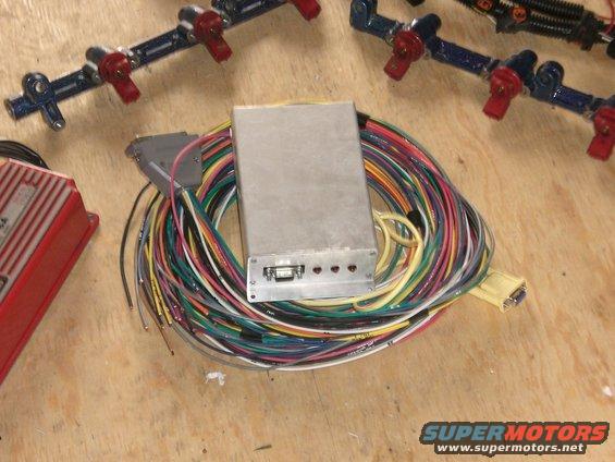 Engine fuel injectors and a large wiring harness with a silver control box