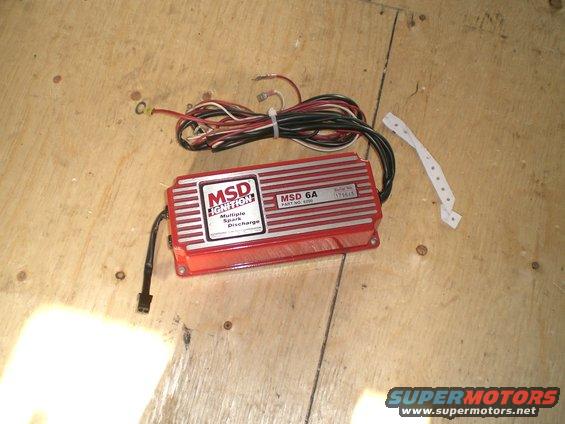 Red MSD Ignition control box with wires on a wooden surface