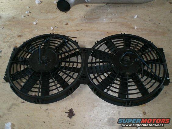 pair of black electric cooling fans mounted together on a bracket
